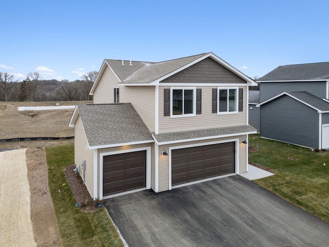 17006 Traprock St NW, Ramsey, MN 55303 - view of front facade featuring driveway, roof with shingles, a front yard, and a garage