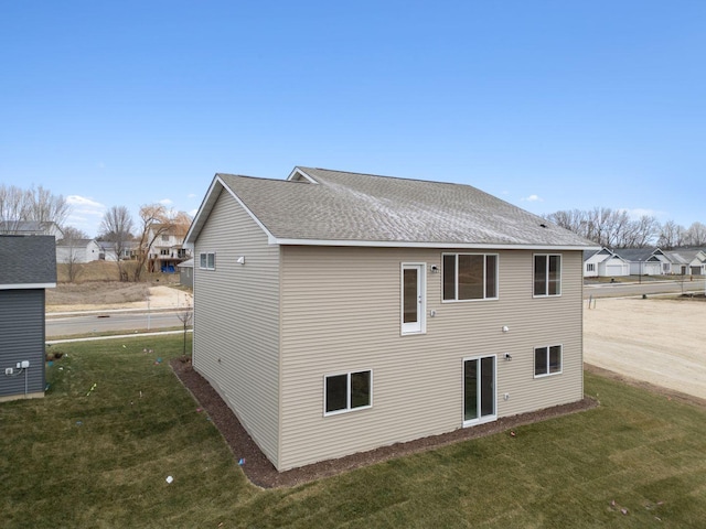 17006 Traprock St NW, Ramsey, MN 55303 - rear view of property with a lawn, a shingled roof, and a residential view