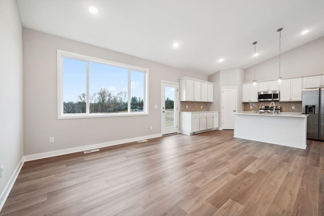 17006 Traprock St NW, Ramsey, MN 55303 - unfurnished living room featuring vaulted ceiling, light wood-style flooring, and recessed lighting