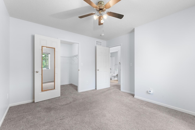 3204 49th St NW, Rochester, MN 55901 - unfurnished bedroom with carpet flooring, a spacious closet, and a ceiling fan