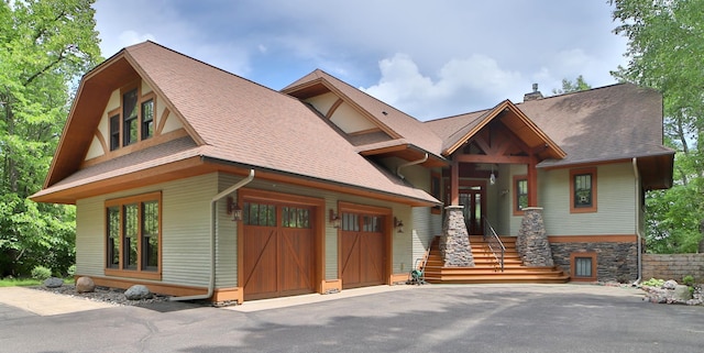 2471 Birch Forest Rd SW, Nisswa, MN 56468 - view of front of home featuring asphalt driveway, a chimney, a shingled roof, and an attached garage