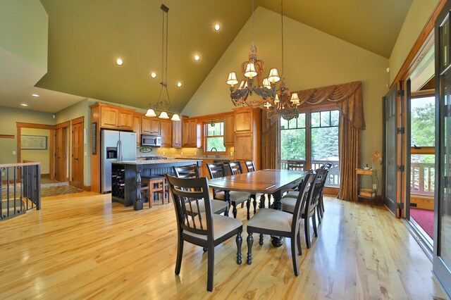 2471 Birch Forest Rd SW, Nisswa, MN 56468 - dining space featuring high vaulted ceiling, a chandelier, light wood finished floors, healthy amount of natural light, and recessed lighting