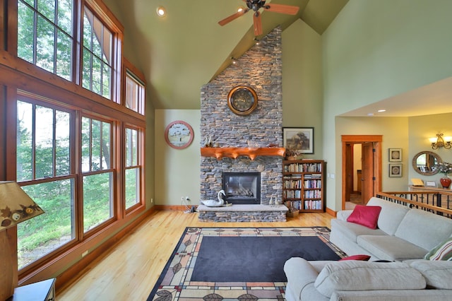 2471 Birch Forest Rd SW, Nisswa, MN 56468 - living area with high vaulted ceiling, a fireplace, plenty of natural light, wood finished floors, and ceiling fan