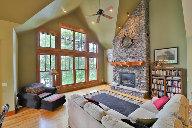 2471 Birch Forest Rd SW, Nisswa, MN 56468 - living area with high vaulted ceiling, wood finished floors, a fireplace, a ceiling fan, and recessed lighting
