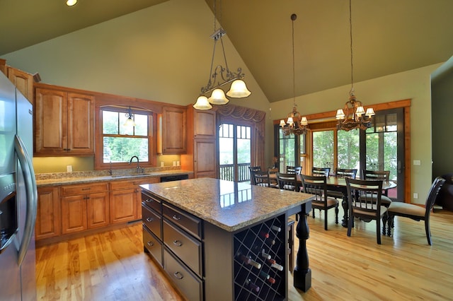 2471 Birch Forest Rd SW, Nisswa, MN 56468 - kitchen featuring stainless steel refrigerator with ice dispenser, a chandelier, high vaulted ceiling, light wood-style flooring, and a kitchen island