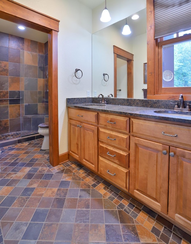 2471 Birch Forest Rd SW, Nisswa, MN 56468 - bathroom featuring double vanity, stone tile floors, and recessed lighting