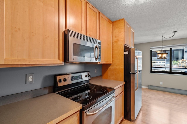 48 Groveland Ter Unit B301, Minneapolis, MN 55403 - kitchen featuring stainless steel appliances, light wood-style flooring, light countertops, a textured ceiling, and a chandelier