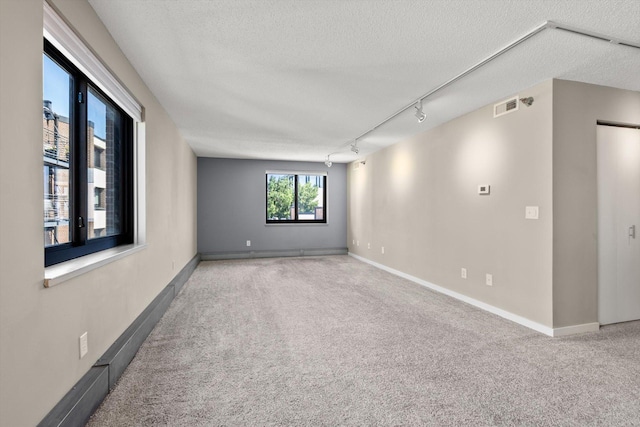 48 Groveland Ter Unit B301, Minneapolis, MN 55403 - carpeted empty room with a textured ceiling and rail lighting