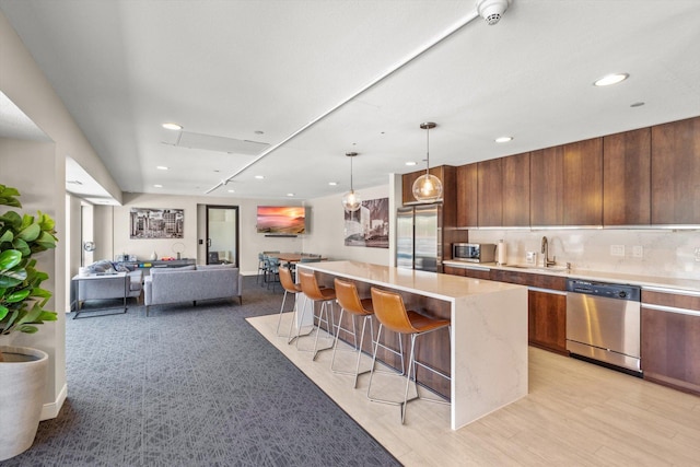 48 Groveland Ter Unit B301, Minneapolis, MN 55403 - kitchen with modern cabinets, a kitchen breakfast bar, stainless steel appliances, recessed lighting, and a kitchen island
