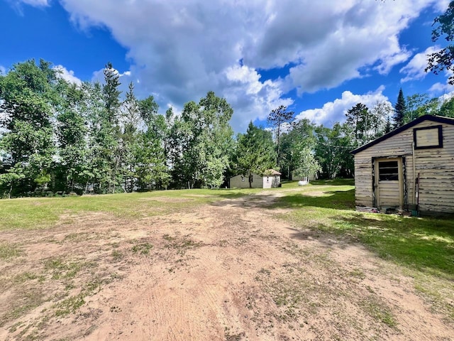 8931 Palm Rd, Britt, MN 55710 - view of grassy yard with a storage unit