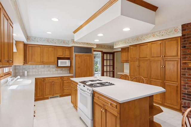 33 Eagle Ridge Rd, North Oaks, MN 55127 - kitchen with white appliances, light floors, light countertops, brown cabinetry, and recessed lighting