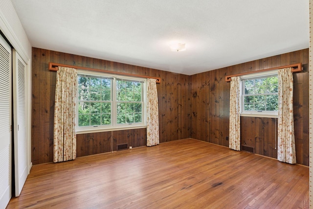 33 Eagle Ridge Rd, North Oaks, MN 55127 - unfurnished bedroom featuring wood finished floors, wood walls, and a closet
