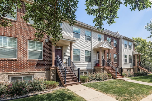 2079 Clover Ridge Dr, Chaska, MN 55318 - townhome / multi-family property with a front lawn and brick siding