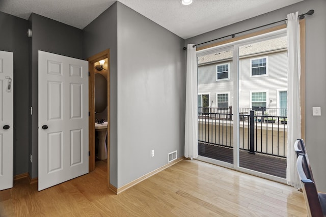 2079 Clover Ridge Dr, Chaska, MN 55318 - unfurnished room featuring light wood finished floors and a textured ceiling