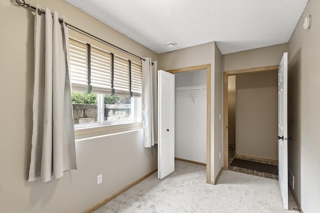 2079 Clover Ridge Dr, Chaska, MN 55318 - unfurnished bedroom featuring a textured ceiling, light colored carpet, and a closet