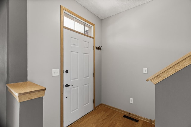 2079 Clover Ridge Dr, Chaska, MN 55318 - foyer entrance with wood finished floors and a textured ceiling