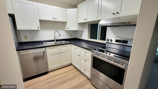 1529 Millpond Ct, Chaska, MN 55318 - kitchen with under cabinet range hood, stainless steel appliances, light wood-style flooring, backsplash, and white cabinets