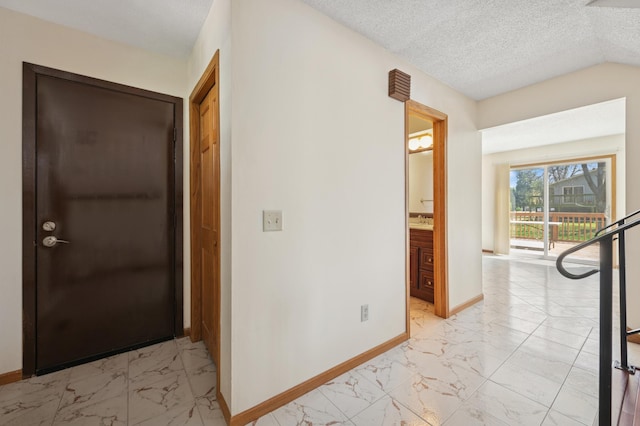 629 73rd Way N, Brooklyn Park, MN 55444 - corridor with light marble finish floors and a textured ceiling