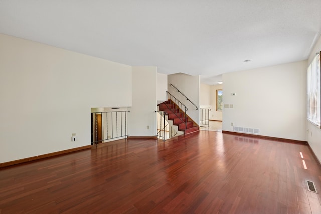 629 73rd Way N, Brooklyn Park, MN 55444 - unfurnished living room featuring wood finished floors, plenty of natural light, and stairs