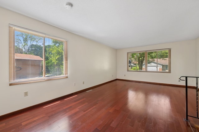 629 73rd Way N, Brooklyn Park, MN 55444 - spare room featuring healthy amount of natural light, a smoke detector, and wood finished floors