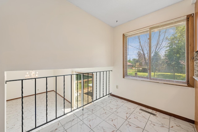 629 73rd Way N, Brooklyn Park, MN 55444 - empty room featuring a chandelier, light marble finish floors, and lofted ceiling