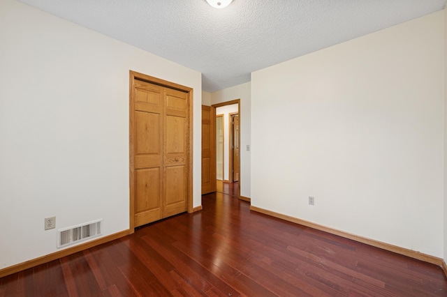 629 73rd Way N, Brooklyn Park, MN 55444 - unfurnished room with dark wood finished floors and a textured ceiling