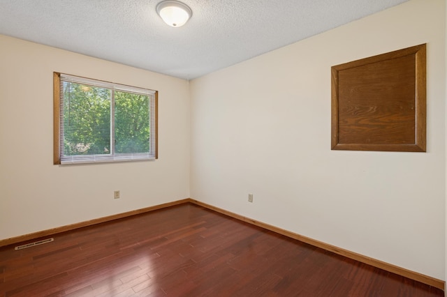 629 73rd Way N, Brooklyn Park, MN 55444 - spare room with wood finished floors and a textured ceiling