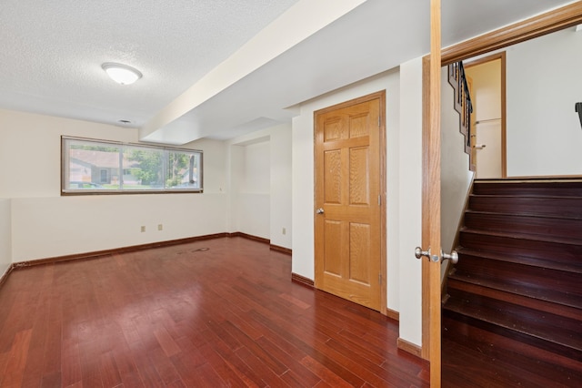 629 73rd Way N, Brooklyn Park, MN 55444 - spare room featuring dark wood-type flooring, stairs, and a textured ceiling