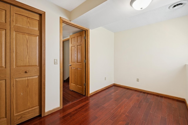 629 73rd Way N, Brooklyn Park, MN 55444 - unfurnished bedroom featuring baseboards and dark wood-type flooring
