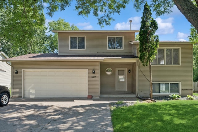 629 73rd Way N, Brooklyn Park, MN 55444 - view of front of house featuring concrete driveway and a front lawn