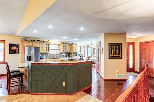 W1162 Aspen Dr, Spring Valley, WI 54767 - kitchen with stainless steel fridge, dark wood-style flooring, a kitchen island, recessed lighting, and ceiling fan