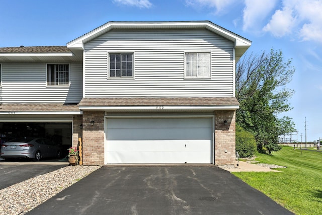 900 Countryside Rd, Waconia, MN 55387 - view of front of property featuring brick siding, a garage, driveway, and a shingled roof
