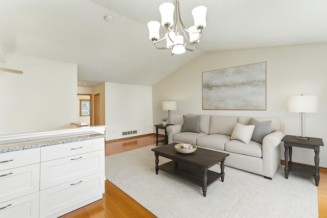 900 Countryside Rd, Waconia, MN 55387 - living area with light wood-style flooring, a chandelier, and vaulted ceiling