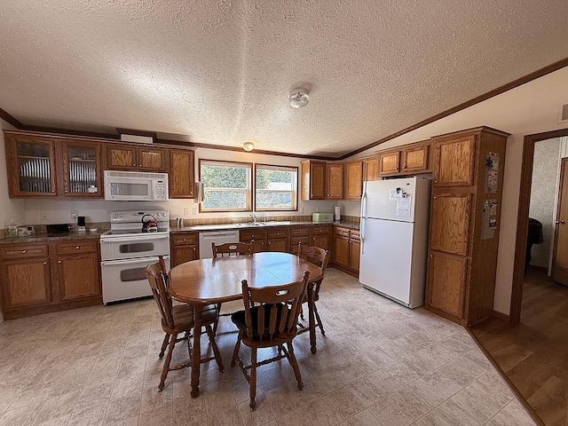 151 Skyline Dr, Granite Falls, MN 56241 - kitchen with white appliances, a textured ceiling, brown cabinetry, ornamental molding, and vaulted ceiling