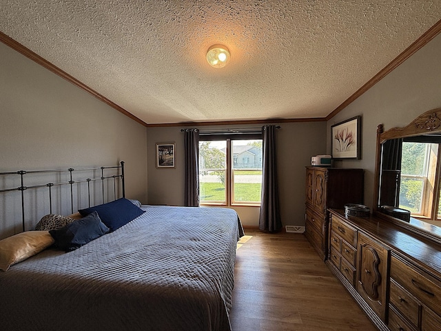 151 Skyline Dr, Granite Falls, MN 56241 - bedroom with lofted ceiling, wood finished floors, multiple windows, ornamental molding, and a textured ceiling