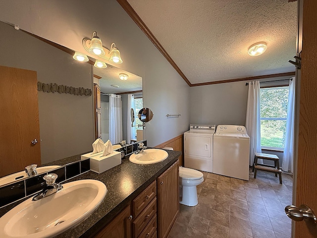 151 Skyline Dr, Granite Falls, MN 56241 - full bathroom featuring washer and clothes dryer, ornamental molding, lofted ceiling, a textured ceiling, and double vanity