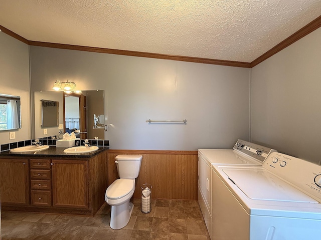 151 Skyline Dr, Granite Falls, MN 56241 - full bathroom with washer and clothes dryer, double vanity, a wainscoted wall, a textured ceiling, and ornamental molding
