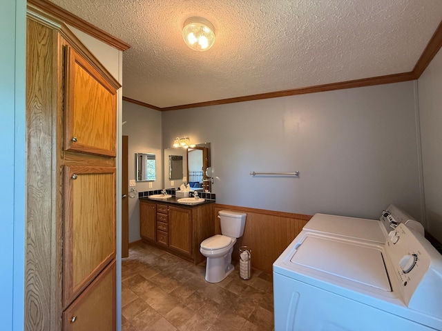 151 Skyline Dr, Granite Falls, MN 56241 - bathroom with separate washer and dryer, vanity, wainscoting, a textured ceiling, and wooden walls