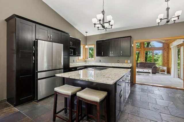 4478 150th St, Savage, MN 55378 - kitchen featuring a chandelier, stainless steel appliances, vaulted ceiling, stone tile floors, and healthy amount of natural light