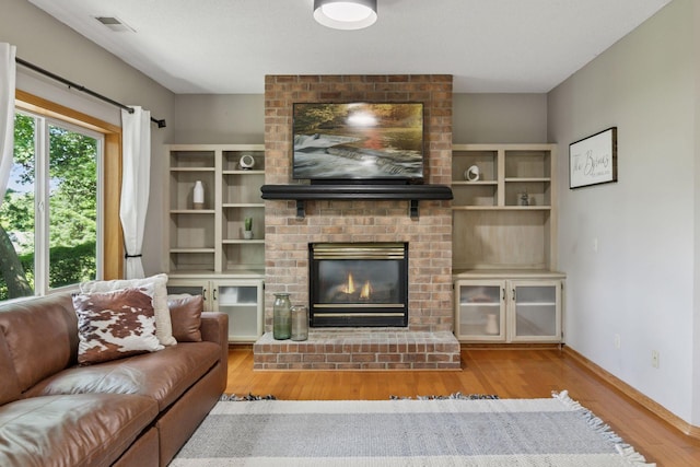 4478 150th St, Savage, MN 55378 - living area featuring wood finished floors and a brick fireplace