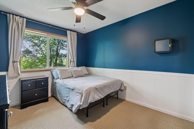 4478 150th St, Savage, MN 55378 - carpeted bedroom with wainscoting, ceiling fan, and a textured ceiling