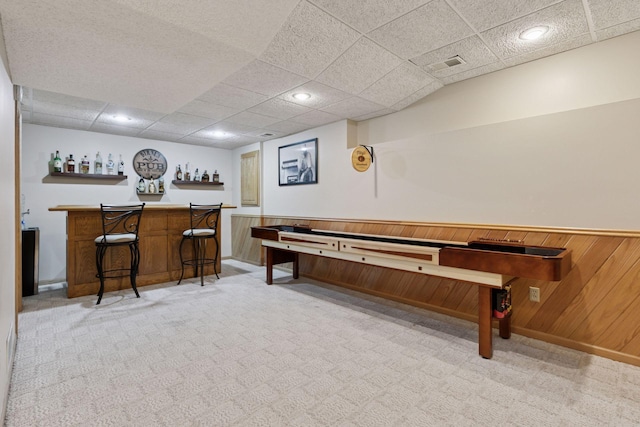 4478 150th St, Savage, MN 55378 - recreation room featuring a bar, carpet flooring, a drop ceiling, and wood walls