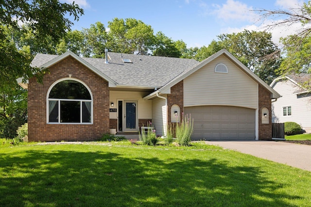 4478 150th St, Savage, MN 55378 - view of front of house with brick siding, concrete driveway, a front yard, roof with shingles, and an attached garage