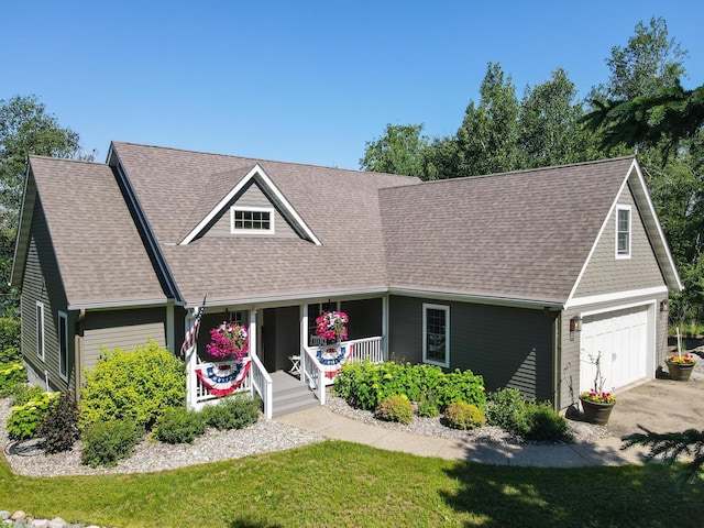 16735 Downey Dr, Park Rapids, MN 56470 - view of front of property featuring covered porch, a garage, roof with shingles, asphalt driveway, and a front lawn