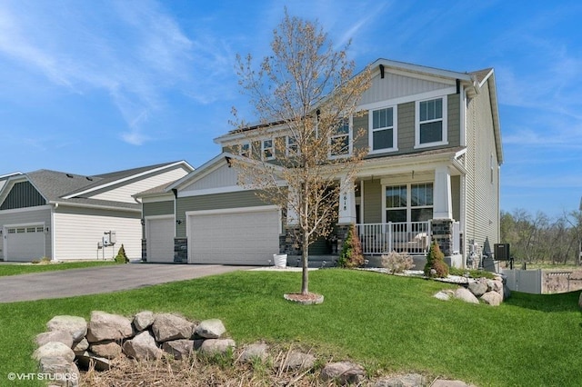 3618 112th Cir NE, Blaine, MN 55449 - craftsman-style house with covered porch, asphalt driveway, a front yard, and a garage
