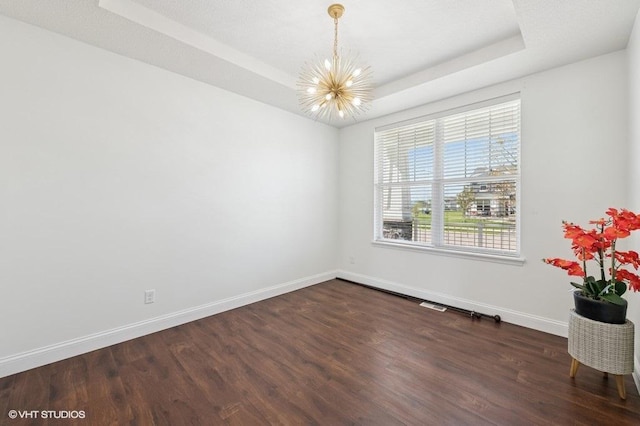 3618 112th Cir NE, Blaine, MN 55449 - unfurnished room with a chandelier, dark wood-type flooring, and a tray ceiling