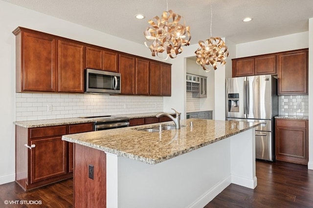 3618 112th Cir NE, Blaine, MN 55449 - kitchen with stainless steel appliances, dark wood-style floors, decorative backsplash, light stone counters, and an island with sink
