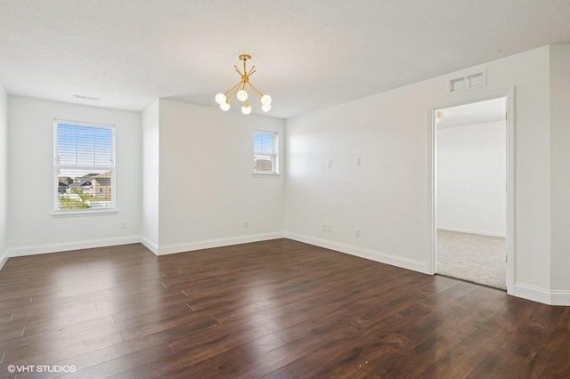 3618 112th Cir NE, Blaine, MN 55449 - spare room with a chandelier, plenty of natural light, and dark wood-style flooring