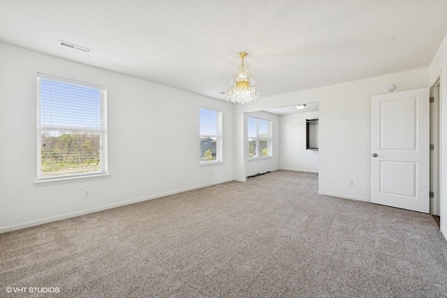 3618 112th Cir NE, Blaine, MN 55449 - carpeted empty room featuring a chandelier and baseboards