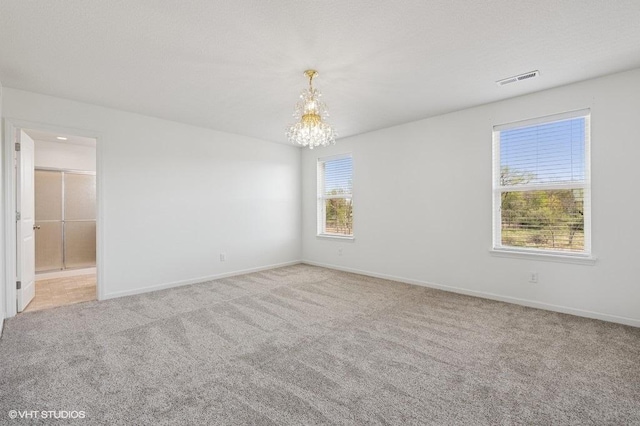 3618 112th Cir NE, Blaine, MN 55449 - spare room featuring a chandelier and carpet flooring